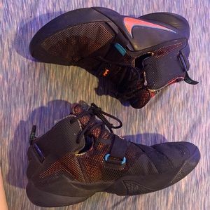 High top black nike basketball shoes. Mens or womens. Orange and Black.